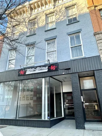 a front view of a building with retail shops