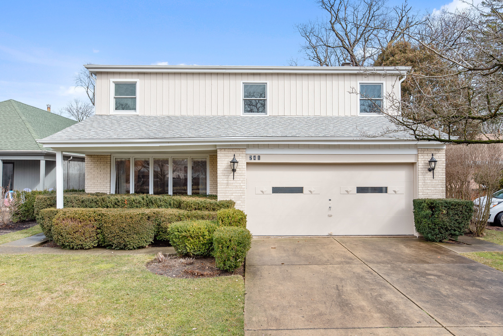 241 Ridge Road Highland Park, IL 60035 - Photo 1 of 31 a front view of a house with a yard and garage