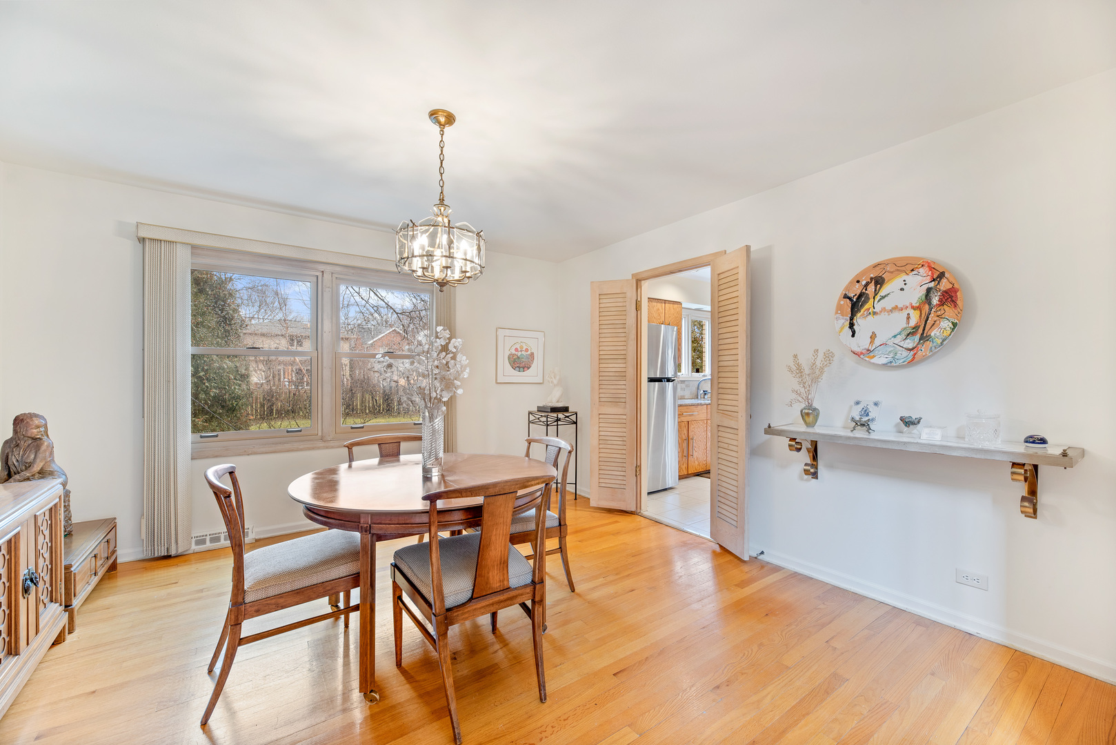 241 Ridge Road Highland Park, IL 60035 - Photo 3 of 31 a dining room with furniture a chandelier and wooden floor