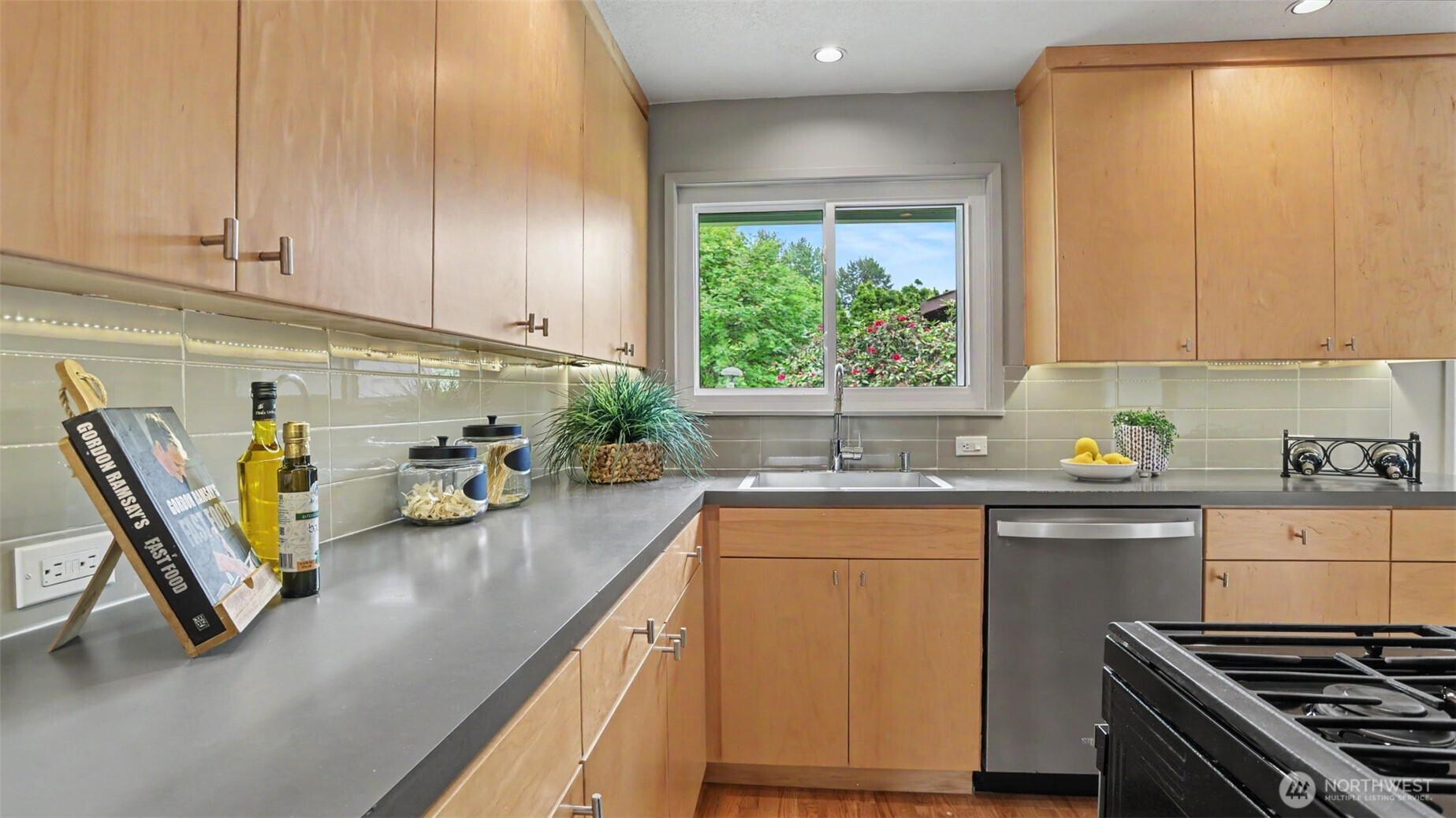 12515 Southeast 171st Street Renton, WA 98058 - Photo 8 of 24 a kitchen with a sink a counter appliances and cabinets