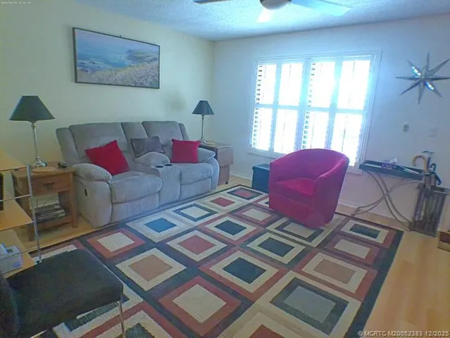 a living room with furniture and a floor to ceiling window