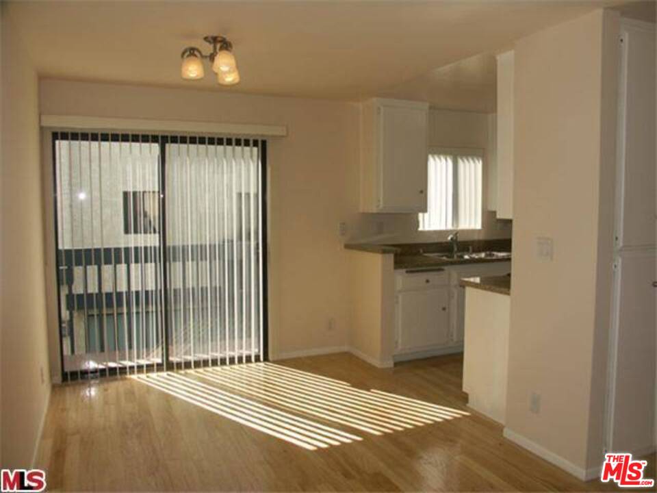 29239 Heathercliff Road, Unit 12 Malibu, CA 90265 - Photo 3 of 8 a view of a livingroom with wooden floor and cabinet