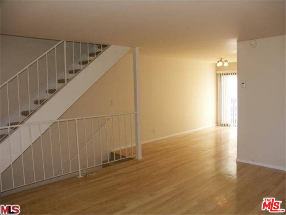 29239 Heathercliff Road, Unit 12 Malibu, CA 90265 - Photo 6 of 8 a view of an empty room with wooden floor