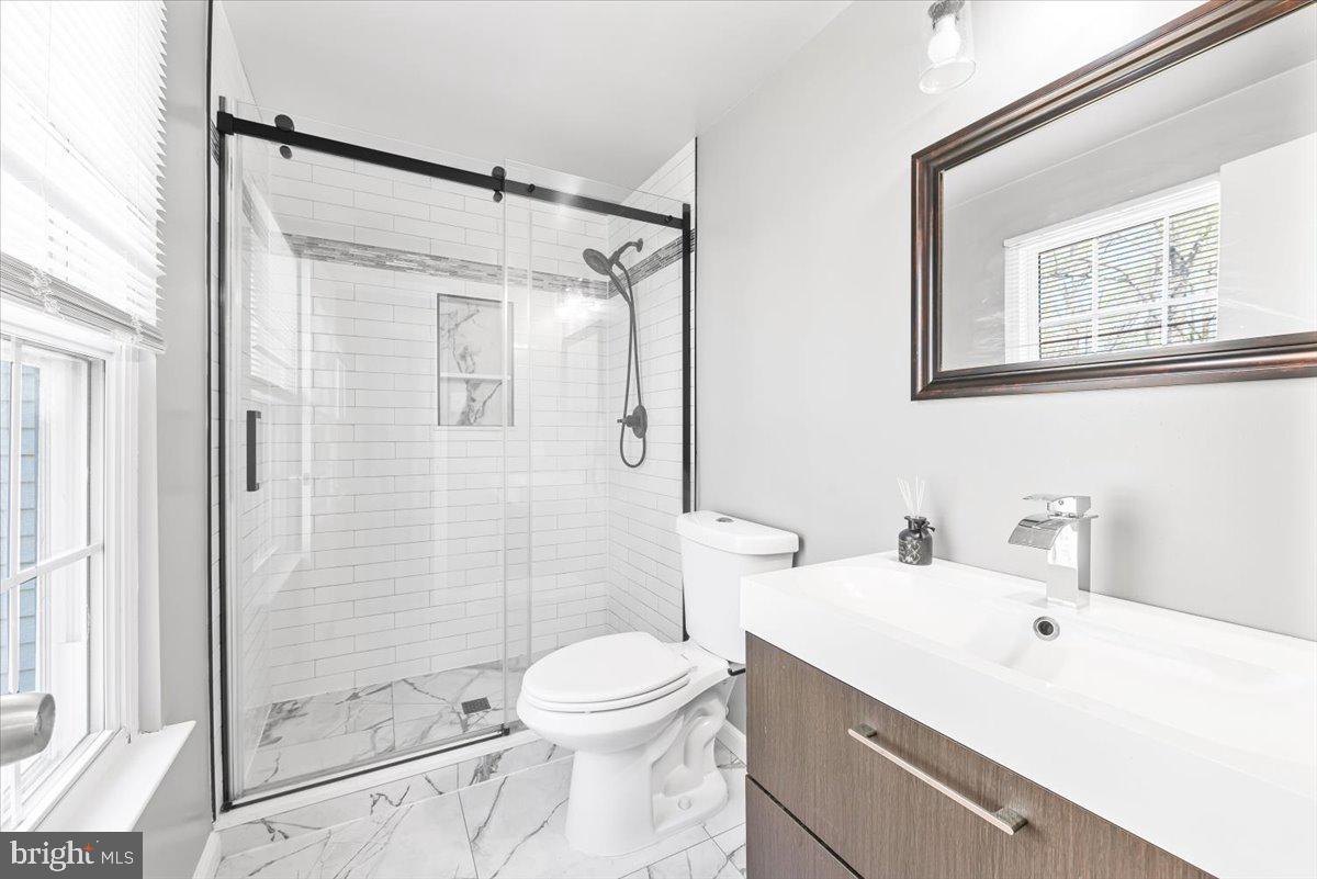 17641 Longview Lane Olney, MD 20832 - Photo 17 of 30 a bathroom with a toilet a sink and shower