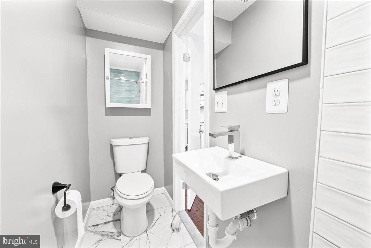 17641 Longview Lane Olney, MD 20832 - Photo 19 of 30 a bathroom with a toilet a sink and a mirror