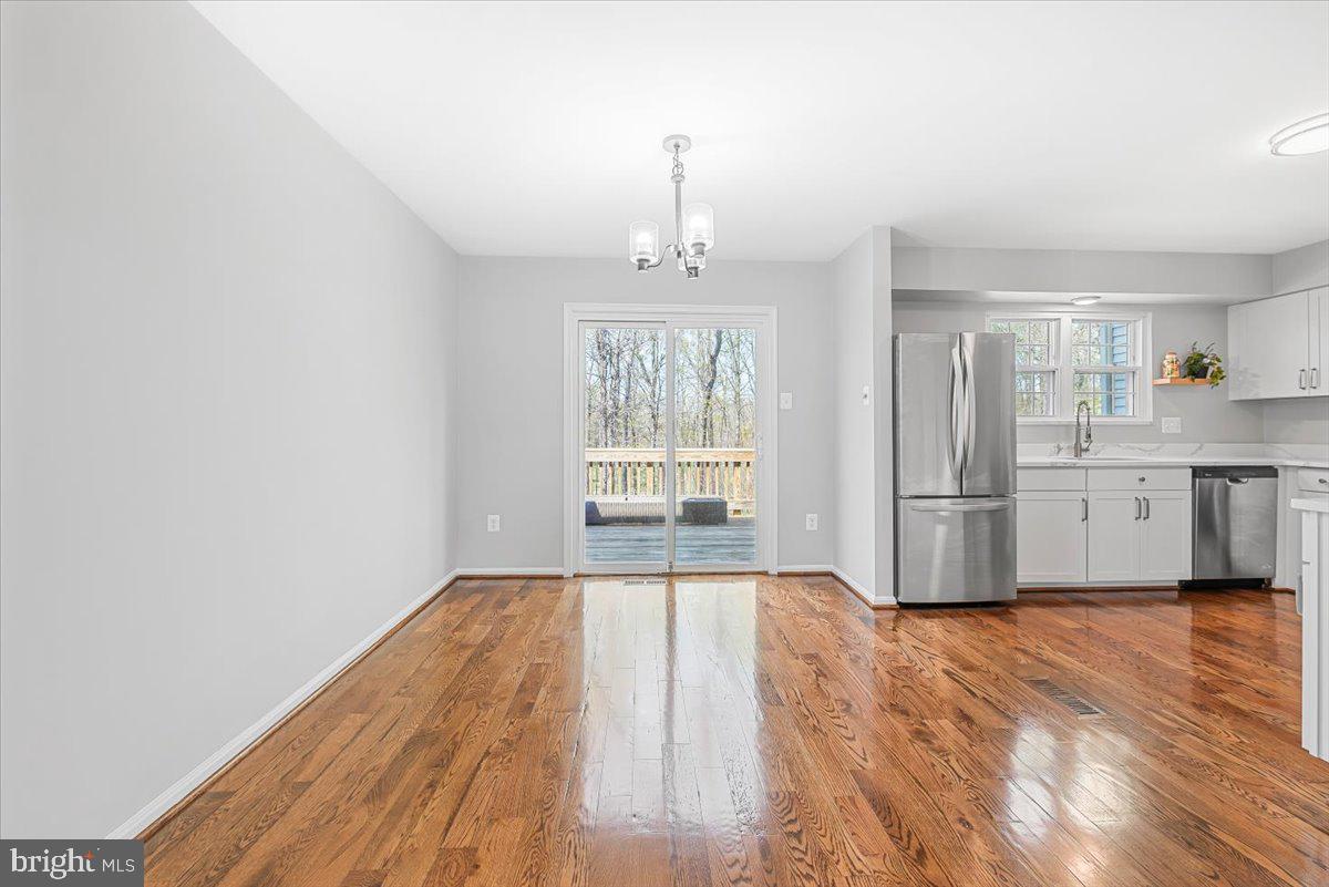 17641 Longview Lane Olney, MD 20832 - Photo 20 of 30 a view of a kitchen with wooden floor and a window
