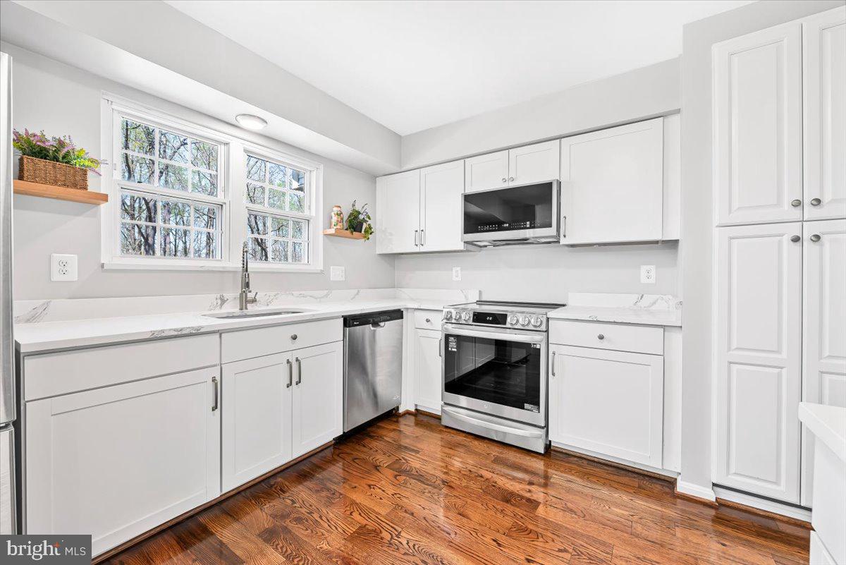 17641 Longview Lane Olney, MD 20832 - Photo 2 of 30 a kitchen with granite countertop cabinets stainless steel appliances and a window