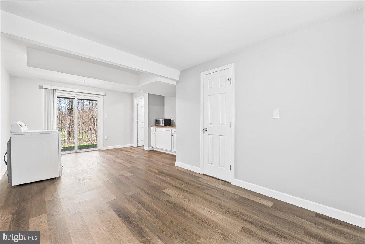 17641 Longview Lane Olney, MD 20832 - Photo 22 of 30 a view of an empty room with wooden floor and a window