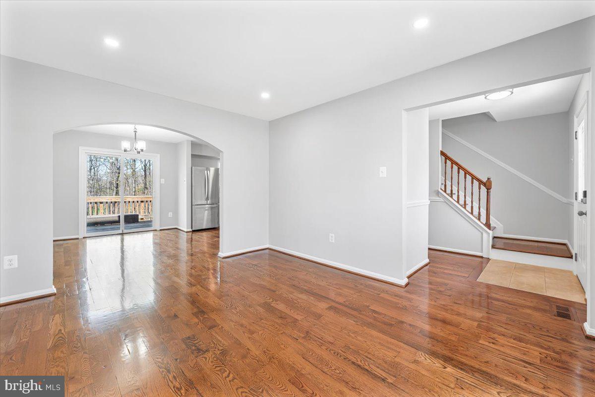 17641 Longview Lane Olney, MD 20832 - Photo 3 of 30 a view of an empty room with wooden floor and a window
