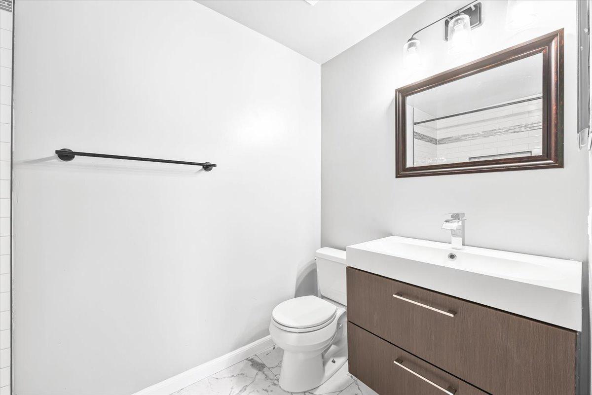 17641 Longview Lane Olney, MD 20832 - Photo 7 of 30 a bathroom with a toilet sink and mirror