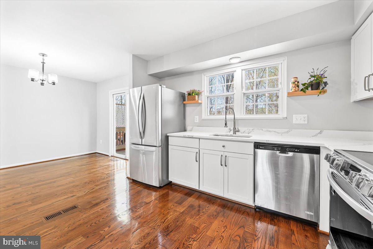 17641 Longview Lane Olney, MD 20832 - Photo 8 of 30 a kitchen with granite countertop a refrigerator and a sink