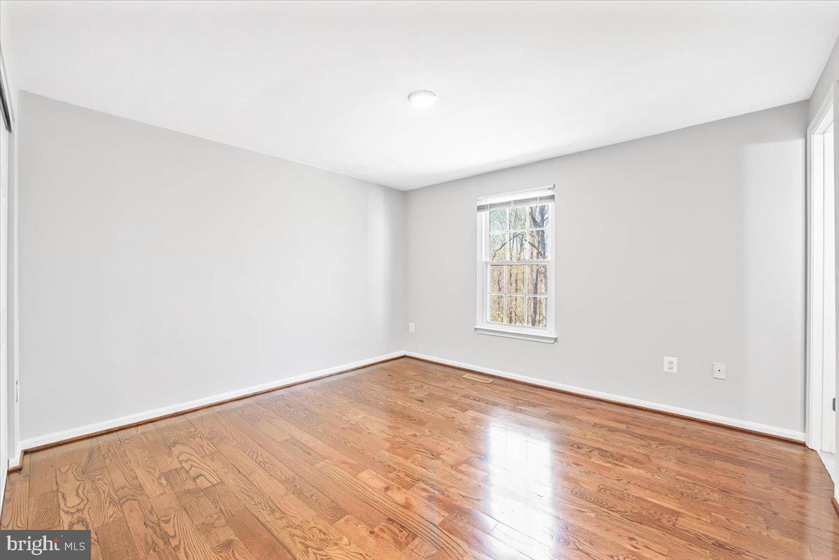 17641 Longview Lane Olney, MD 20832 - Photo 10 of 30 a view of an empty room with wooden floor and a window