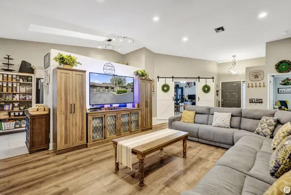 a living room with furniture and kitchen view