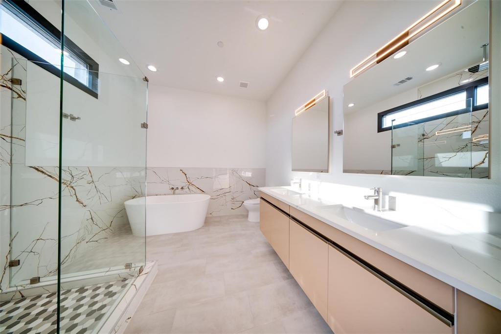 1920 Caddo Street, Unit 104 Dallas, TX 75204 - Photo 12 of 15 a bathroom with a large tub and double vanity