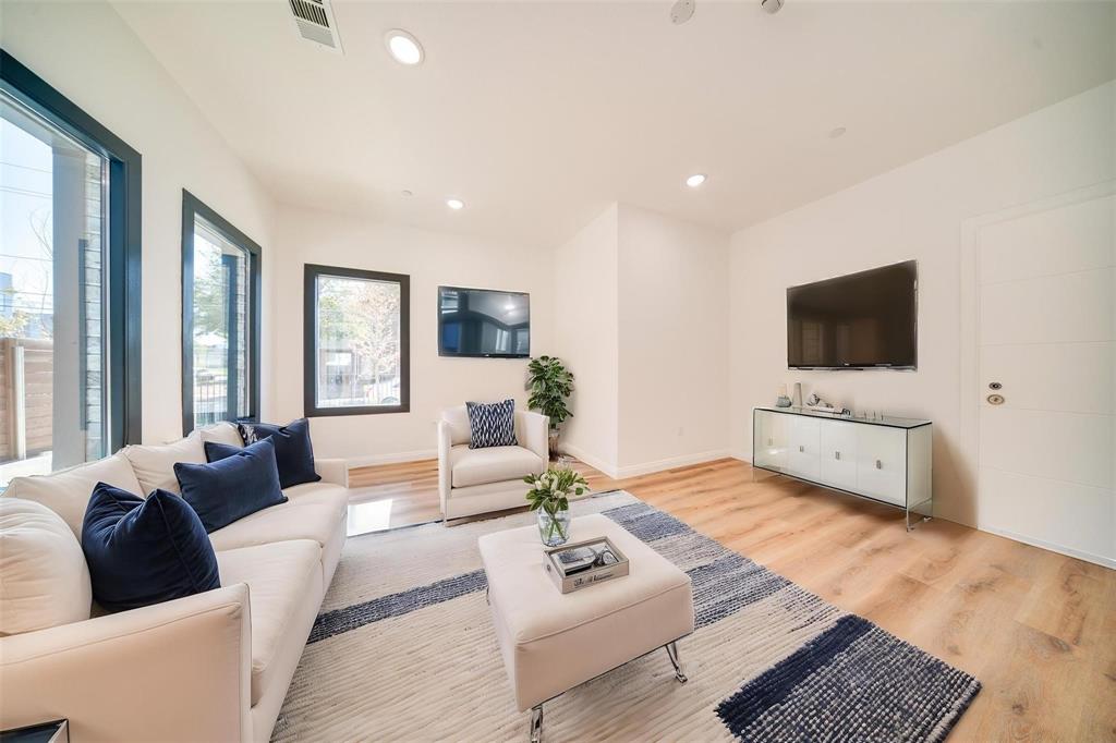1920 Caddo Street, Unit 104 Dallas, TX 75204 - Photo 3 of 15 a living room with furniture and a flat screen tv