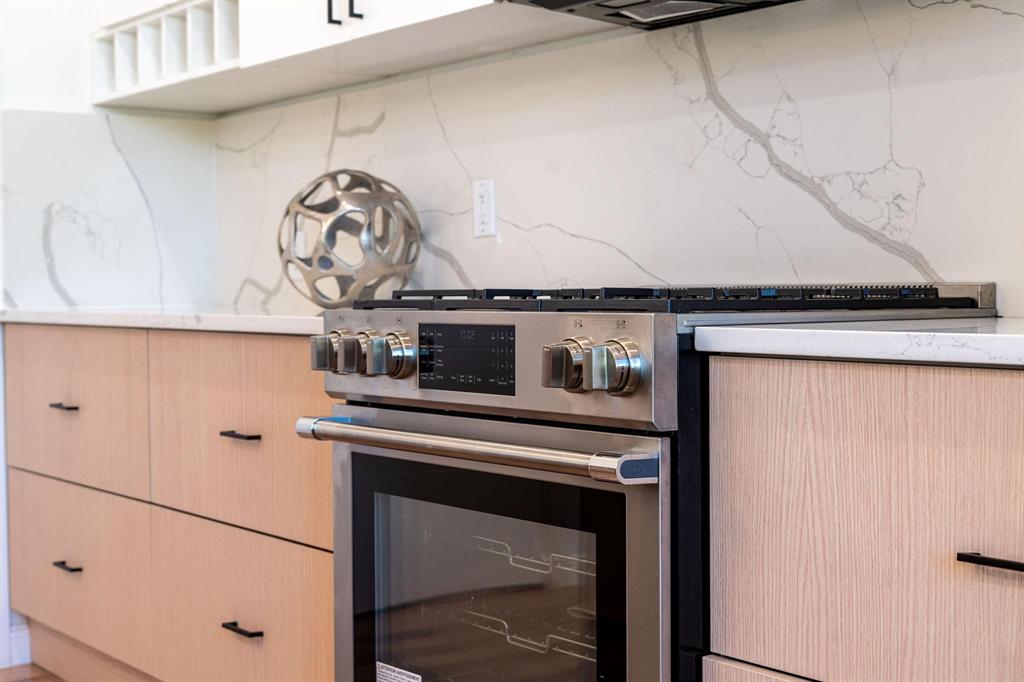 1920 Caddo Street, Unit 104 Dallas, TX 75204 - Photo 7 of 15 a stove top oven sitting inside of a kitchen