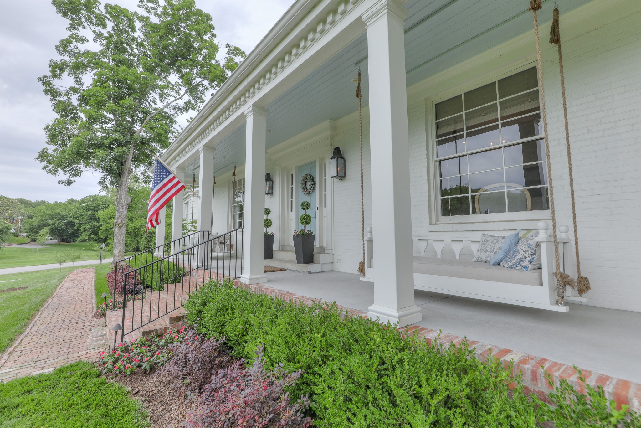 a view of a house with a yard and sitting area