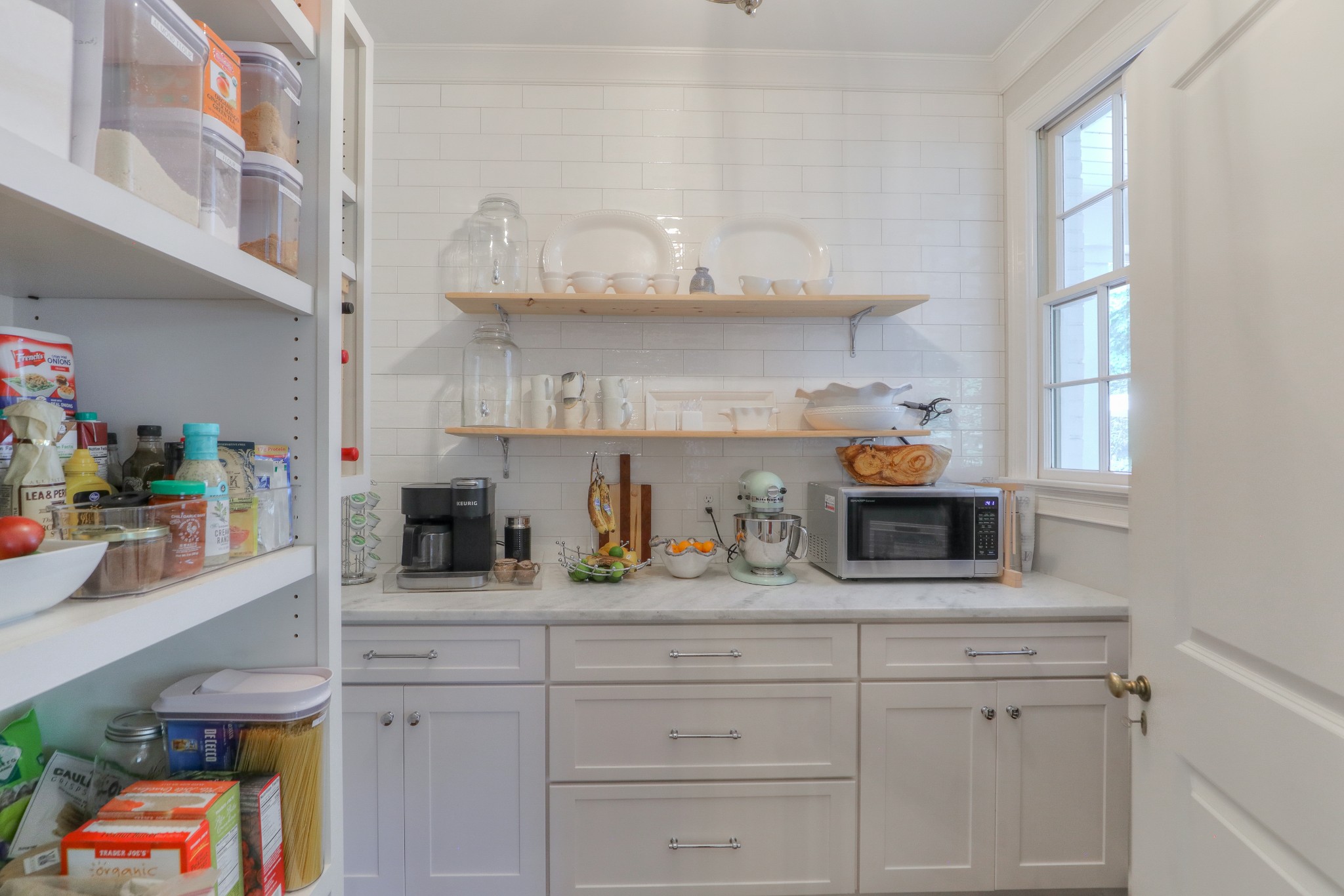 2315 Valley Brook Road Nashville, TN 37215 - Photo 42 of 67 a kitchen with white cabinets and a wooden floor