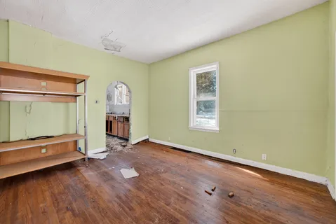 a view of room with window and wooden floor