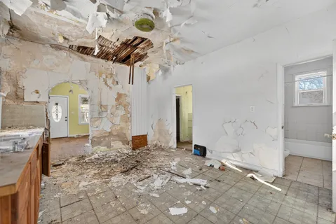 a view of a room with wooden floor and a shower