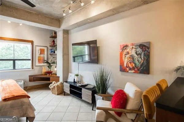 a living room with furniture and a large window