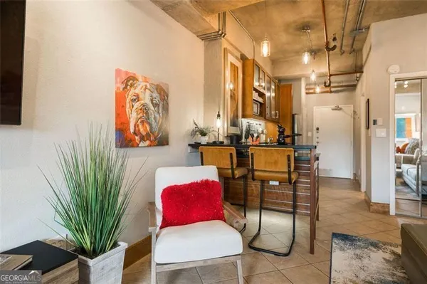 a living room with furniture plant and a window
