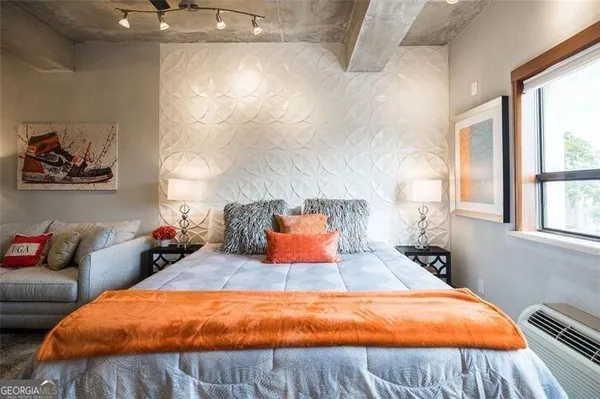 a bedroom with a bed and window