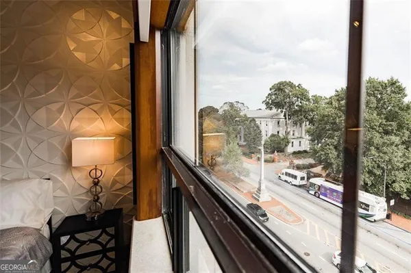 a view of a balcony with wooden floor and iron stairs