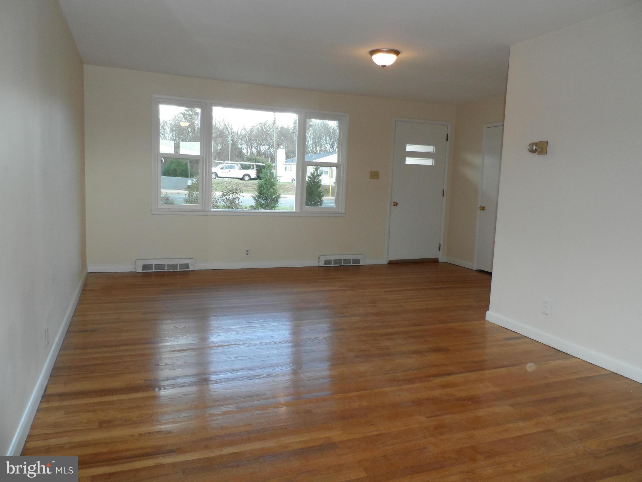 147 Deacon Road Fredericksburg, VA 22405 - Photo 4 of 16 an empty room with wooden floor and windows