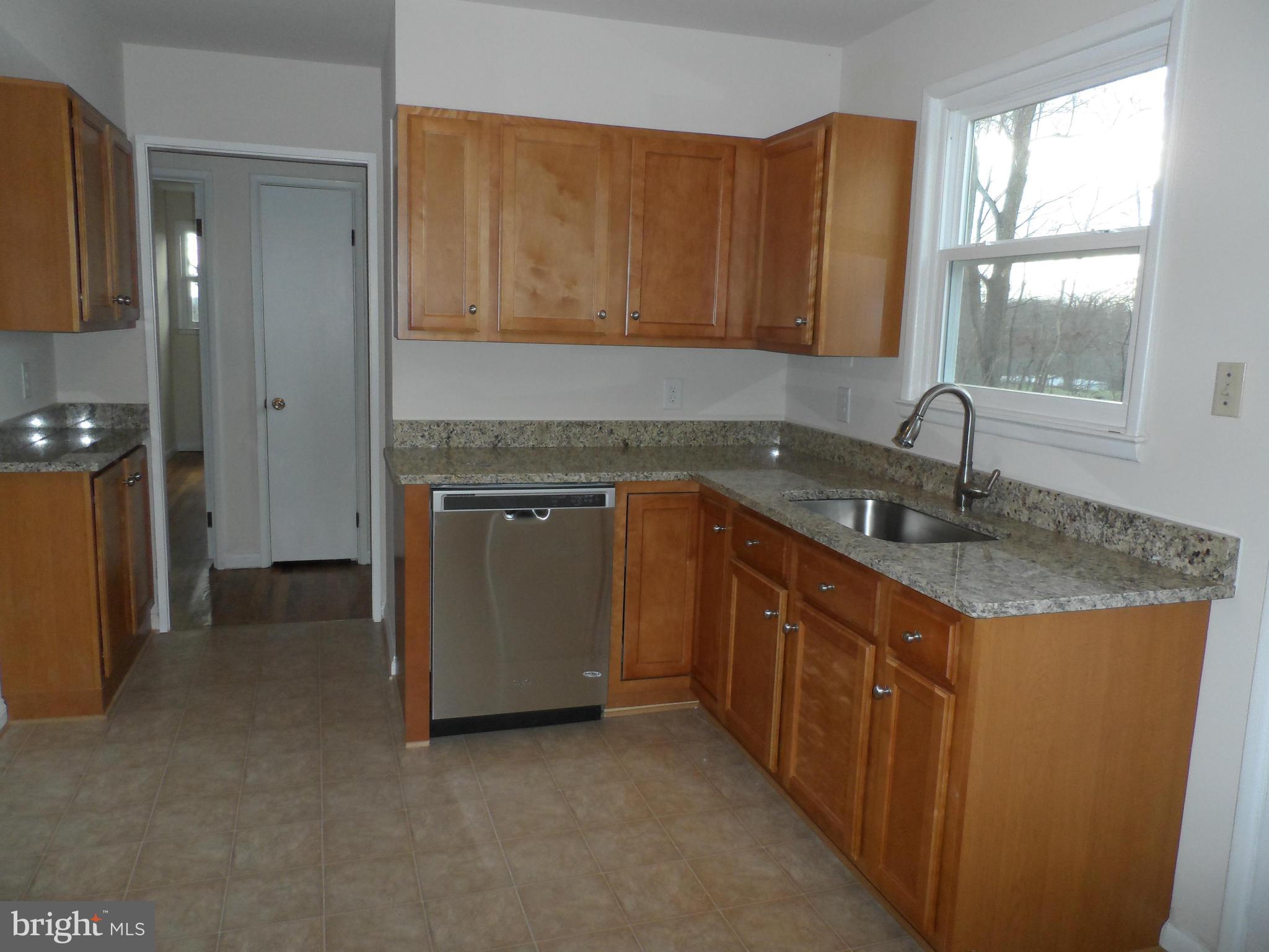 147 Deacon Road Fredericksburg, VA 22405 - Photo 6 of 16 a kitchen with stainless steel appliances granite countertop a sink stove and cabinets