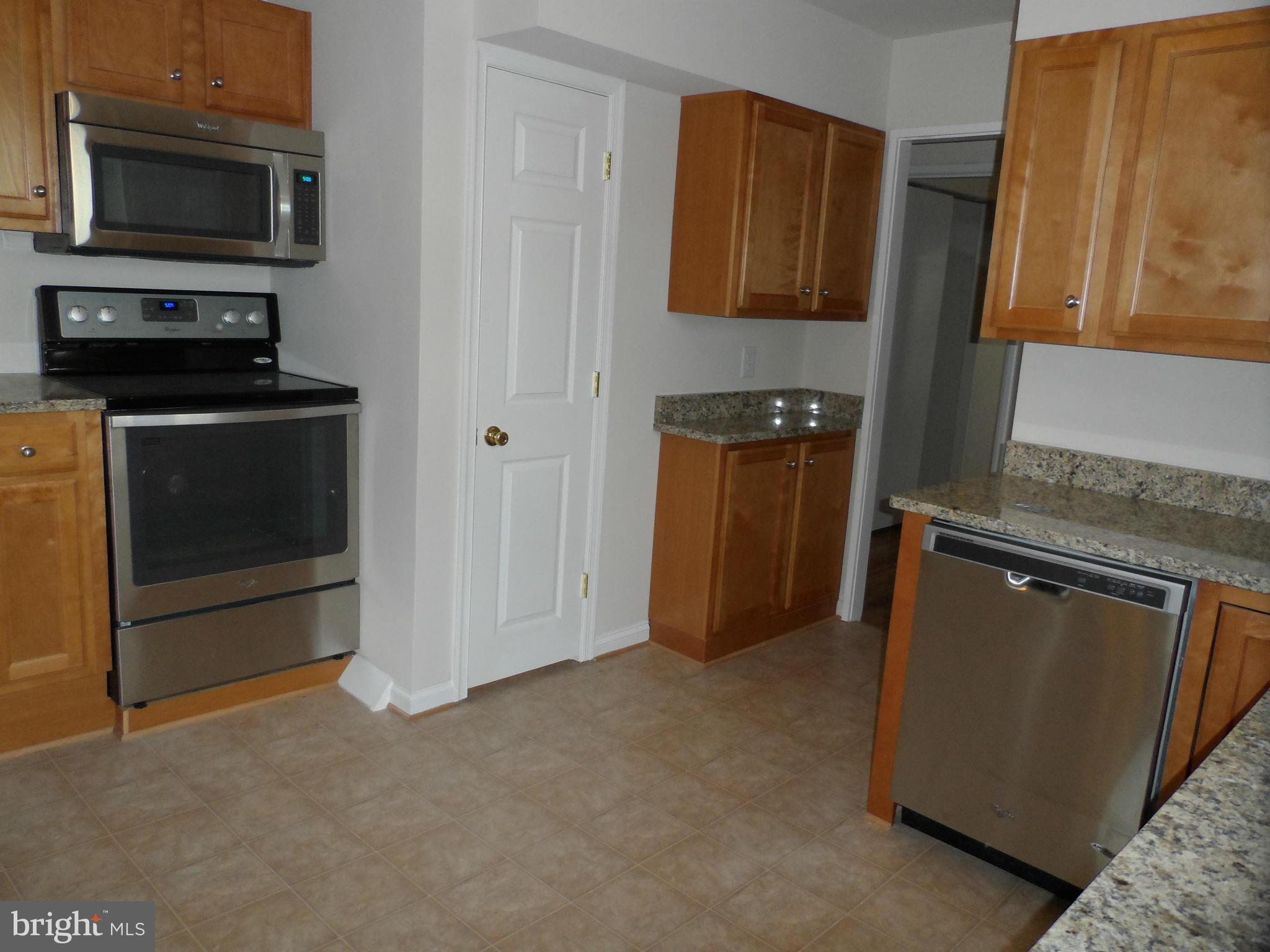 147 Deacon Road Fredericksburg, VA 22405 - Photo 8 of 16 a kitchen with stainless steel appliances granite countertop a refrigerator and a stove top oven