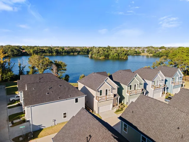 an aerial view of a house with outdoor space and lake view