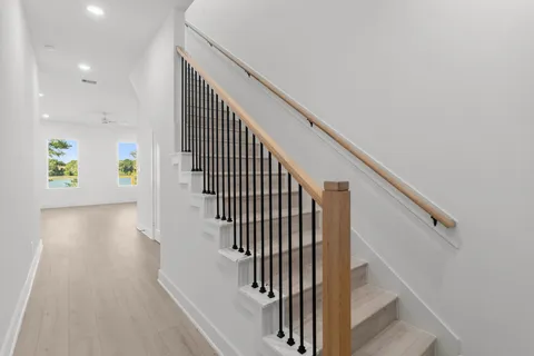 a view of entryway and hall with wooden floor