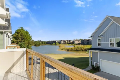 a view of swimming pool with outdoor seating and lake view