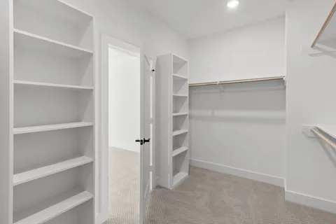 a view of walk in closet with empty racks