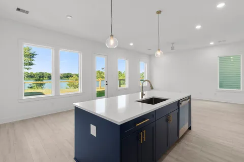 a kitchen with a sink a counter top space and a window