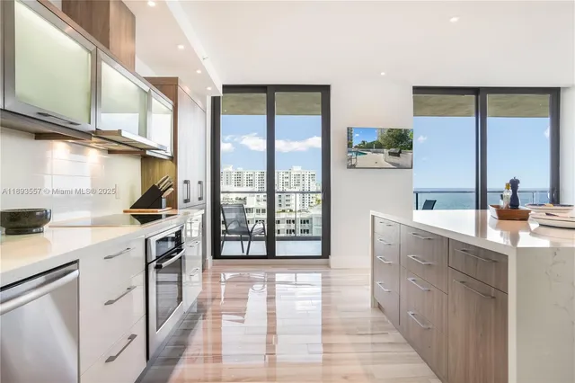 a large kitchen with lots of counter top space and stainless steel appliances