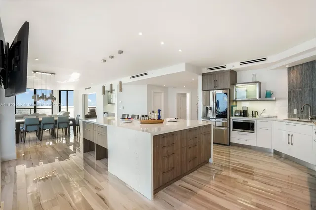a living room with furniture and floor to ceiling window