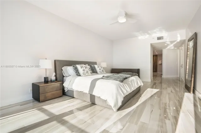 a bedroom with a bed and a large window