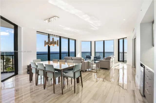 a living room with furniture a large window and wooden floor