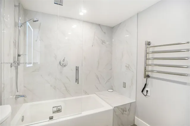 a dining room with furniture and a floor to ceiling window