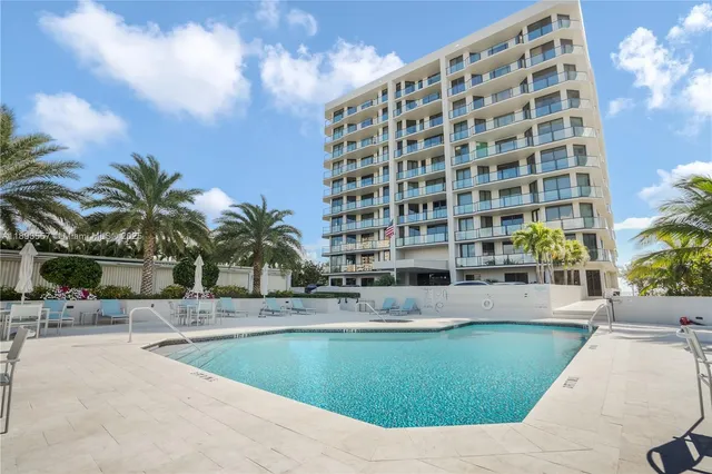 a view of a pathway both side of grassy field with shrub