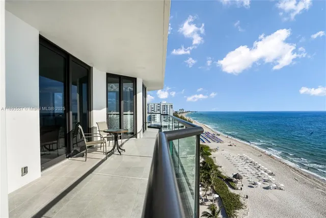 a view of a dining room with furniture large windows and wooden floor