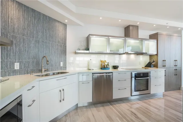 a large kitchen with stainless steel appliances lots of counter space sink and cabinets