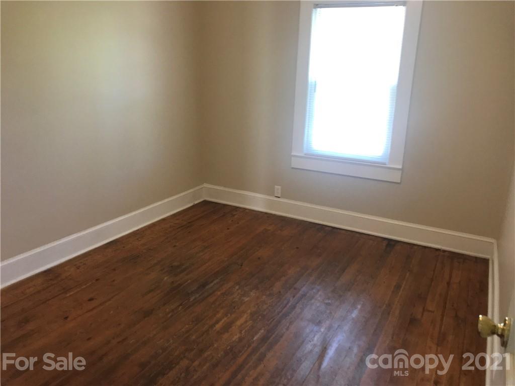 332 Crawley Drive Morganton, NC 28655 - Photo 11 of 15 an empty room with wooden floor and windows
