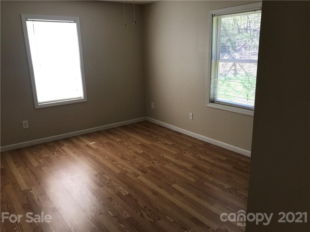 332 Crawley Drive Morganton, NC 28655 - Photo 14 of 15 an empty room with wooden floor and windows
