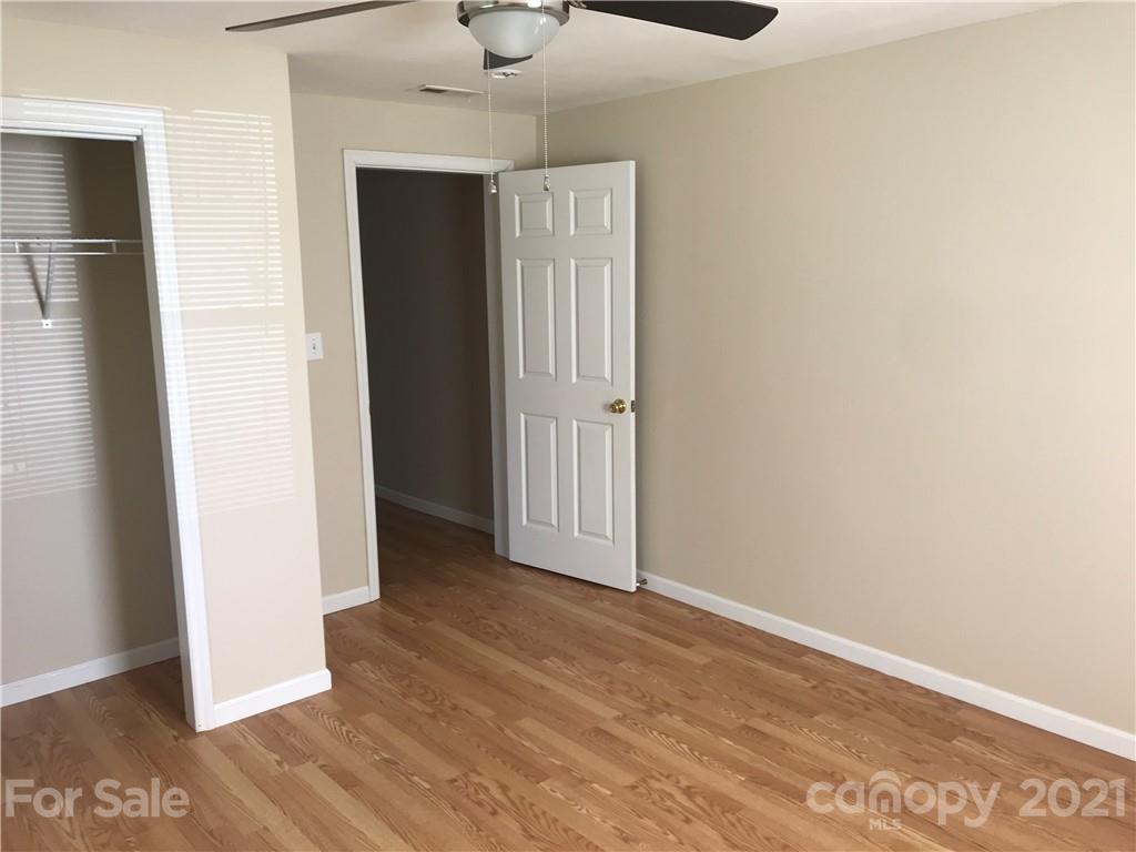 332 Crawley Drive Morganton, NC 28655 - Photo 15 of 15 an empty room with wooden floor and hallway