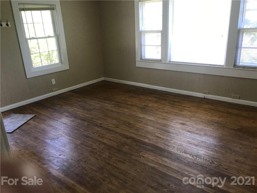 332 Crawley Drive Morganton, NC 28655 - Photo 3 of 15 an empty room with wooden floor and windows