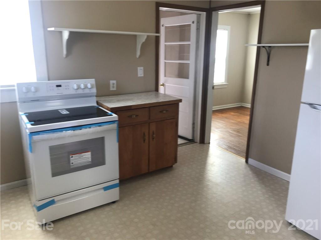 332 Crawley Drive Morganton, NC 28655 - Photo 5 of 15 a kitchen with a stove and a refrigerator