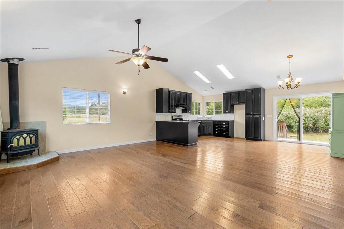 1196 Freshwater Road Eureka, CA 95503 - Photo 9 of 34 a view of a kitchen with a sink a kitchen island wooden floor and a fireplace